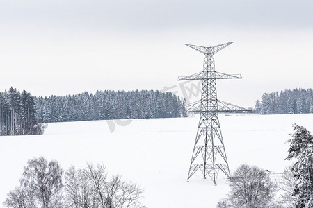 冬季能源摄影照片_冬季高压输电塔施工。组装好的输电线支架，准备安装。