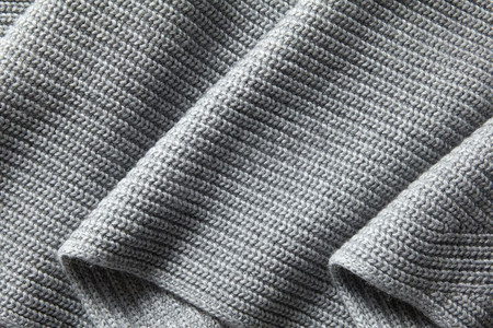 灰色羊毛针织面料褶皱。自然悬垂针织纹理。天然悬垂针织纹理