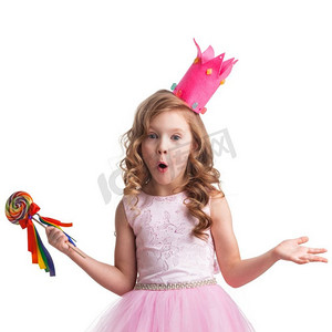 惊喜的糖果公主惊讶的小糖果公主女孩在冠拿着大棒棒糖和耸耸肩