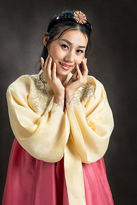 韩服图腾摄影照片_穿着传统韩国服装（韩服）的韩国妇女在黑色背景在工作室。美丽的韩国文化。
