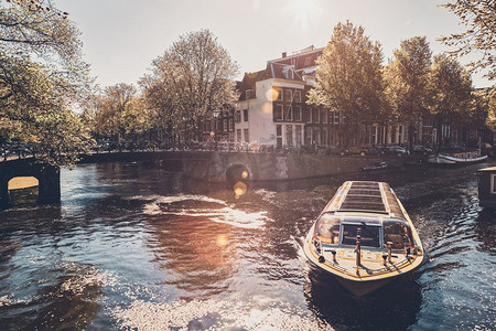 日落时分，有游船和老房子的阿姆斯特丹运河。荷兰阿姆斯特达。带游船的阿姆斯特丹运河