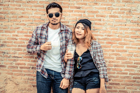 快乐的年轻男女在街上喝咖啡。夫妻和年轻人的生活方式。