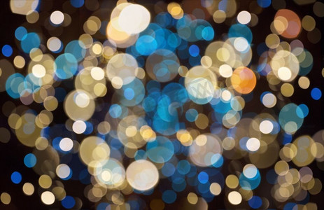 节日和派对概念-蓝色、黄色和黑色圣诞背景与模糊的波克灯。圣诞背景，带波克灯