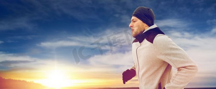 天桥摄影照片_健身，人和健康的生活方式概念-年轻人跑沿冬天桥。傍晚慢跑的男子