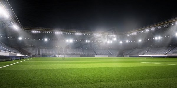 灯火通明的足球场。空荡荡的足球绿地背景图