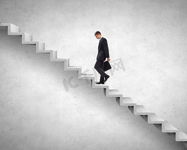 在职业阶梯上往上爬。年轻商人走上代表成功理念的楼梯