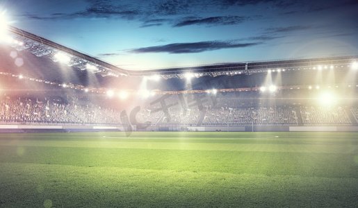 足球运动背景图摄影照片_灯火通明的足球场。空荡荡的足球绿地背景图