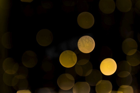 闪光动效摄影照片_圣诞节抽象散焦发光的光黑暗的背景