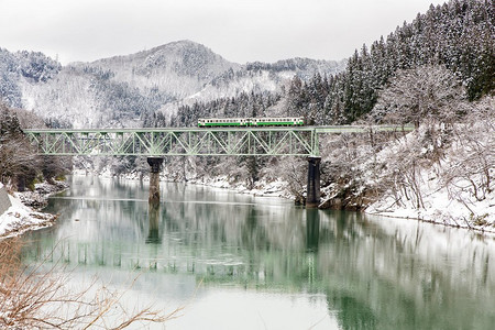 铁轨风景摄影照片_冬日风景雪在桥上的训练