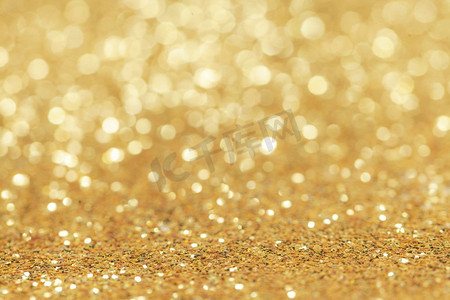闪金色的光摄影照片_抽象的金色闪光波克节日派对背景。抽象的金色闪光背景