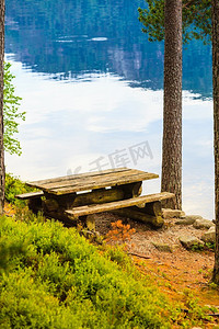 野餐现场木桌和长凳在诺勒森林公园，欧洲。露营地与野餐桌在诺富特公园