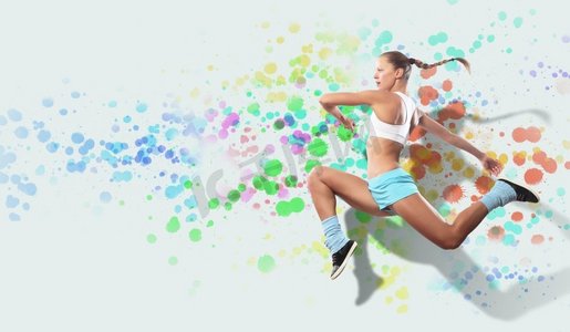 体育女子跳跃的形象。图像的运动女孩在跳跃反对彩色斑点背景
