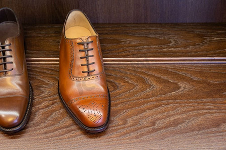 棕色全粒面皮鞋在男鞋精品店的木制陈列中展示。男士鞋类精品店