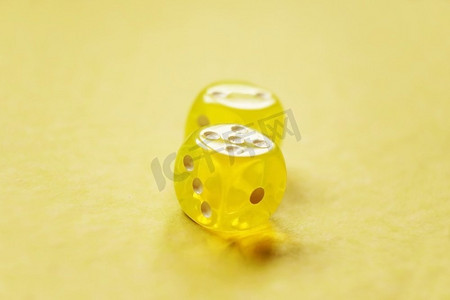 一个充满活力的单色宏观与景深约两个黄色玻璃赌博骰子与两个数字，二和五在黄色背景。