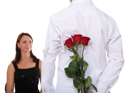 红色捧花摄影照片_一位有爱心的男人为他的女人捧着一朵红玫瑰