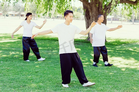 陈式太极拳摄影照片_人们在公园里练太极拳。夏天人们在公园里练太极拳