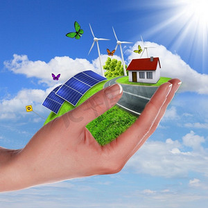 生态环境保护地球摄影照片_用太阳能电池牵着绿色地球的手