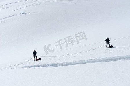 登山徒步的人摄影照片_新西兰一群人走在新西兰阿尔卑斯山的雪