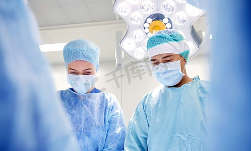 中老年群体摄影照片_外科、医学和人的概念--医院手术室中的外科医生群体。医院手术室里的一群外科医生