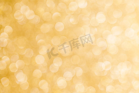 金色金光摄影照片_闪亮的金光背景。闪亮的金色波克闪光灯抽象背景，圣诞新年晚会庆祝概念