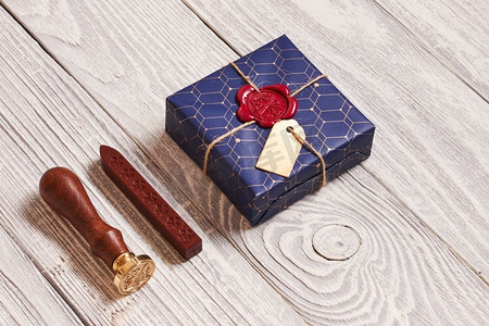 创意包装和装饰的圣诞礼物盒子和白色木质背景上的蜡封印章