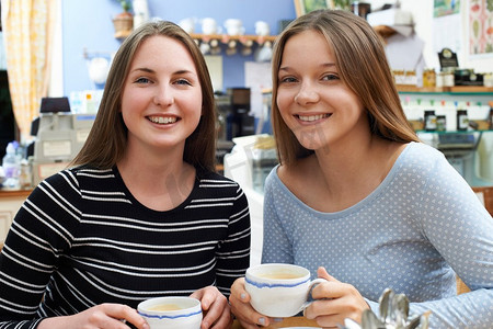 两个十几岁的女性朋友在咖啡馆相遇的肖像