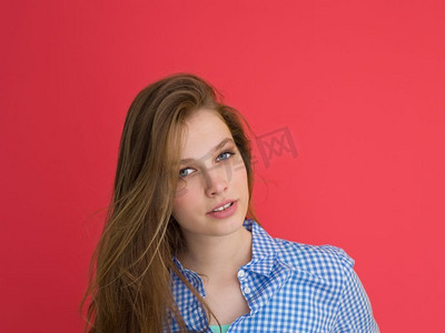 一位美丽积极的年轻女子玩耍着红色背景下孤立的丝质长发