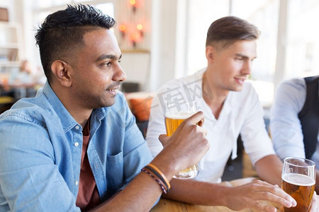 人，男性友谊和交流理念--快乐的朋友在酒吧或酒吧喝啤酒。快乐的男性朋友在酒吧或酒吧喝啤酒
