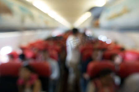 商用飞机摄影照片_商用飞机上旅客的模糊背景