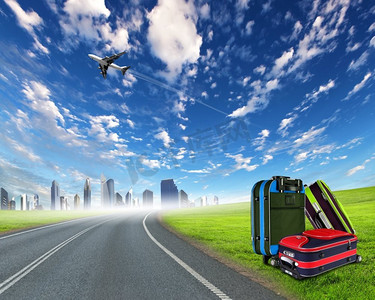 红色手提箱和飞机在蓝天之上