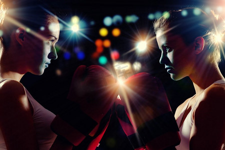 两个女拳击手。两名戴着手套的拳击手女子在比赛前相互打招呼