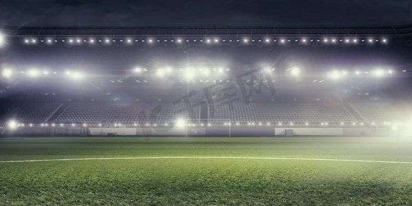 灯火通明的足球场。空荡荡的足球绿地背景图