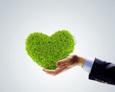 绿化理念。人类双手的形象，植物形状像心脏。环境保护