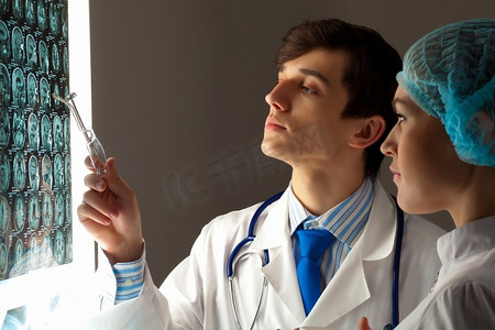 两名医生检查X光结果。两名年轻的两名医生讨论X光结果的图像