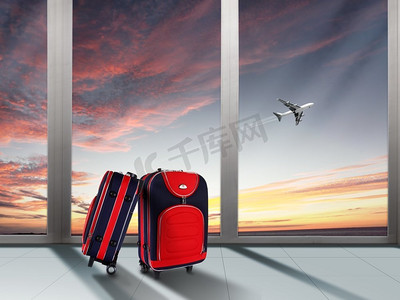 红色手提箱和飞机在蓝天之上