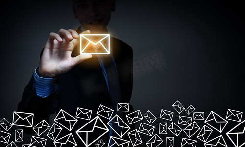 商务电子邮件的概念。商人用手指拿着电子邮件标志的近距离观察