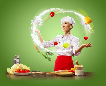 厨师女厨师摄影照片_杂耍女厨师杂耍女亚洲厨师反对颜色背景