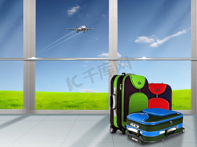 红色公文包摄影照片_头顶蓝天上的红色行李箱和飞机
