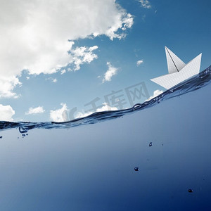 纸船。风浪中漂浮在水面上的纸船