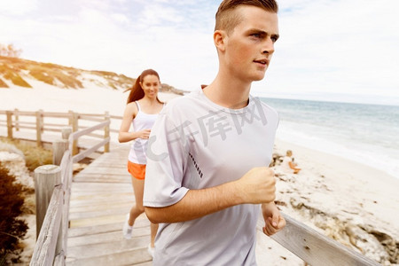 跑步者。一对年轻夫妇在海滩上奔跑。跑步者。一对年轻夫妇一起在海滩上跑步