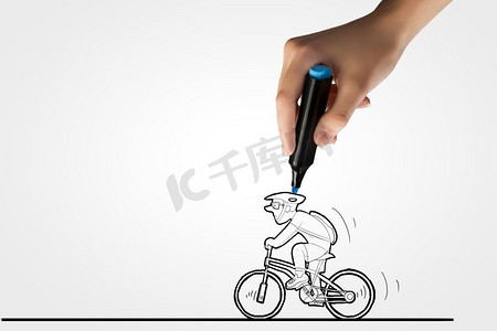 手绘自行车摄影照片_画着脸的自行车车手。骑自行车的人漫画和人的手绘线条