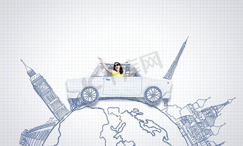 驾驶位摄影照片_在世界各地旅行。一位年轻女子骑着一辆纸制的汽车
