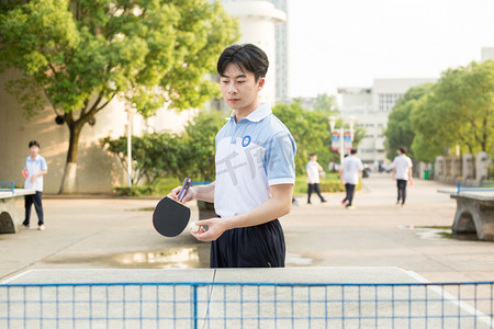 加油活动摄影照片_少年草坪男孩男生健身帅哥运动踢球乒乓球球拍加油操场