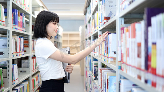 图书馆看书的女大学生学习阅读书写作业