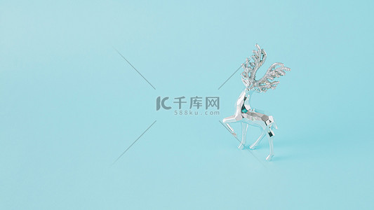 winter字背景图片_Winter arrangement made of silver reindeer on a blue background. Minimal Christmas concept. New Year inspiration.