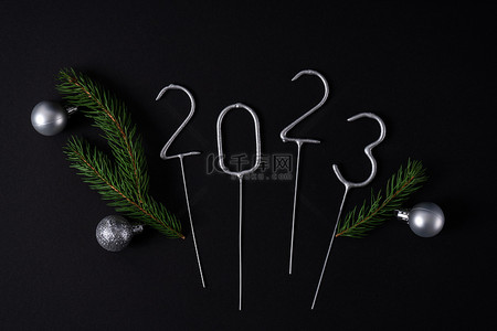 2023路上背景图片_新的2023年的数字与杉木绳和银圣诞球。平躺在床上