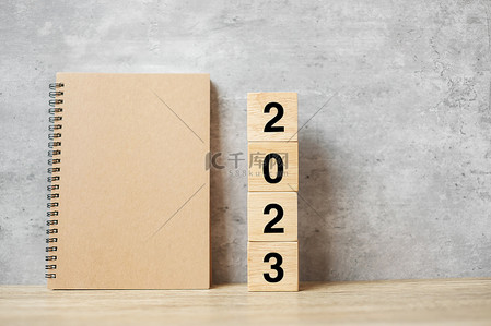 2023目标背景图片_2023年新年快乐，有空白笔记本和木制号码。倒计时、决心、目标、计划、行动及使命概念