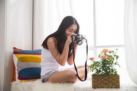 青年女人拿着相机拍照