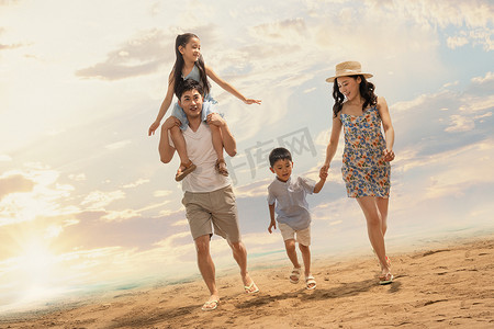 幸福的一家四口在沙滩上散步