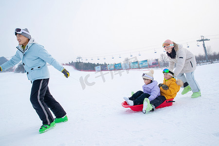玩雪上滑板幸福的一家四口